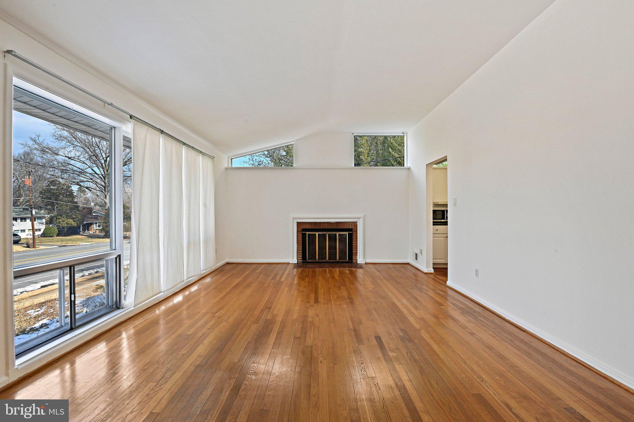 6713 Old Chesterbrook Road McLean, VA 22101 - Photo 16 of 38 a view of empty room with wooden floor and fireplace