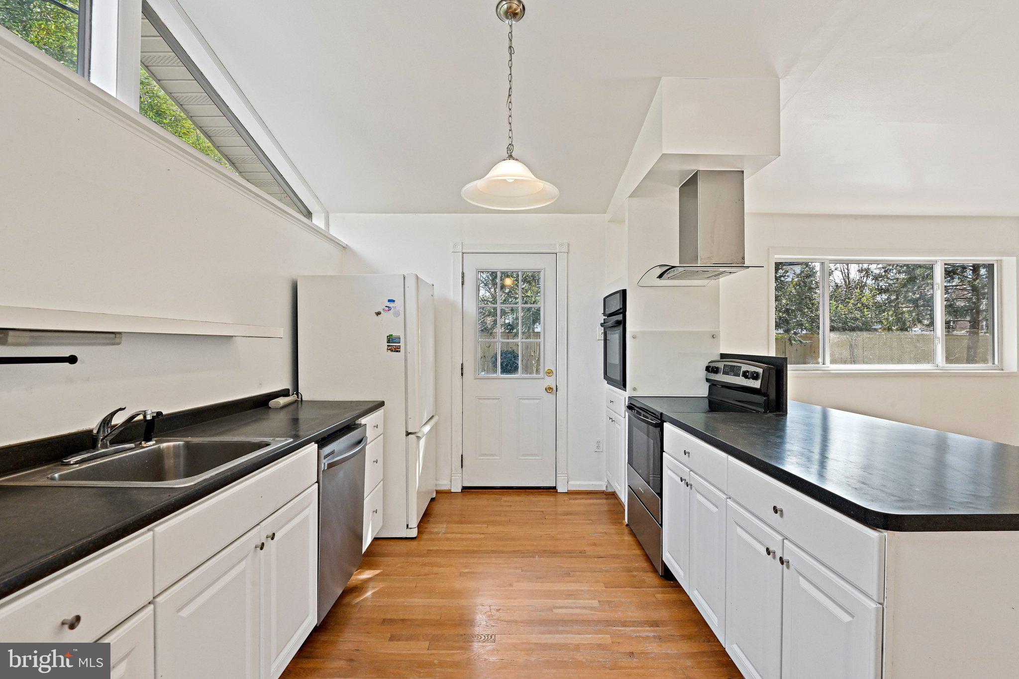 6713 Old Chesterbrook Road McLean, VA 22101 - Photo 19 of 38 a kitchen with granite countertop a sink and refrigerator