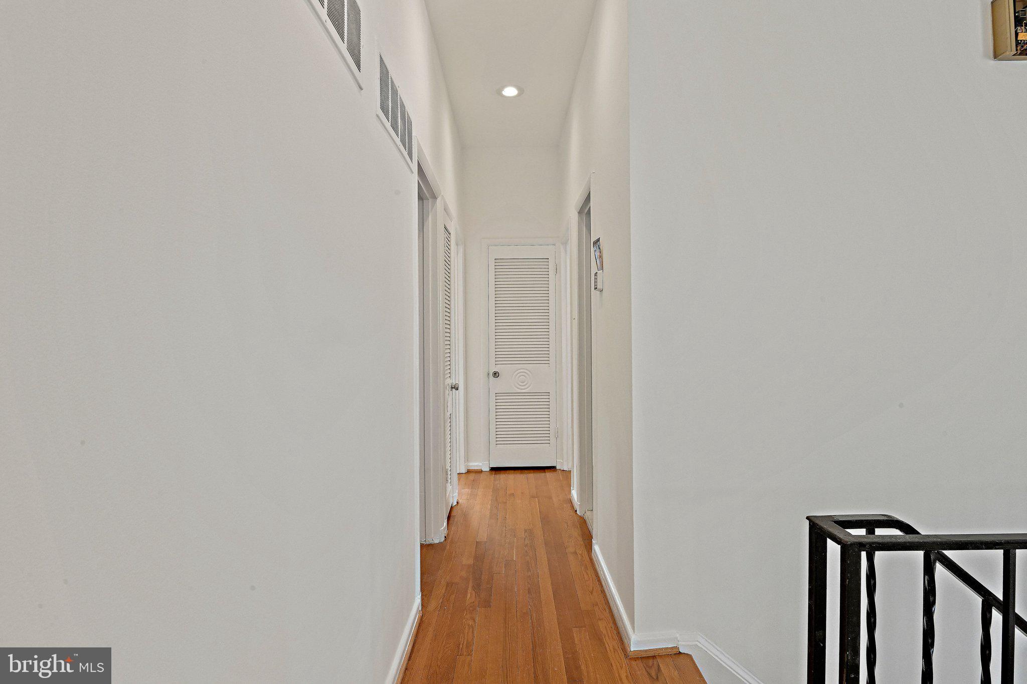 6713 Old Chesterbrook Road McLean, VA 22101 - Photo 25 of 38 a view of a hallway with wooden floor and staircase