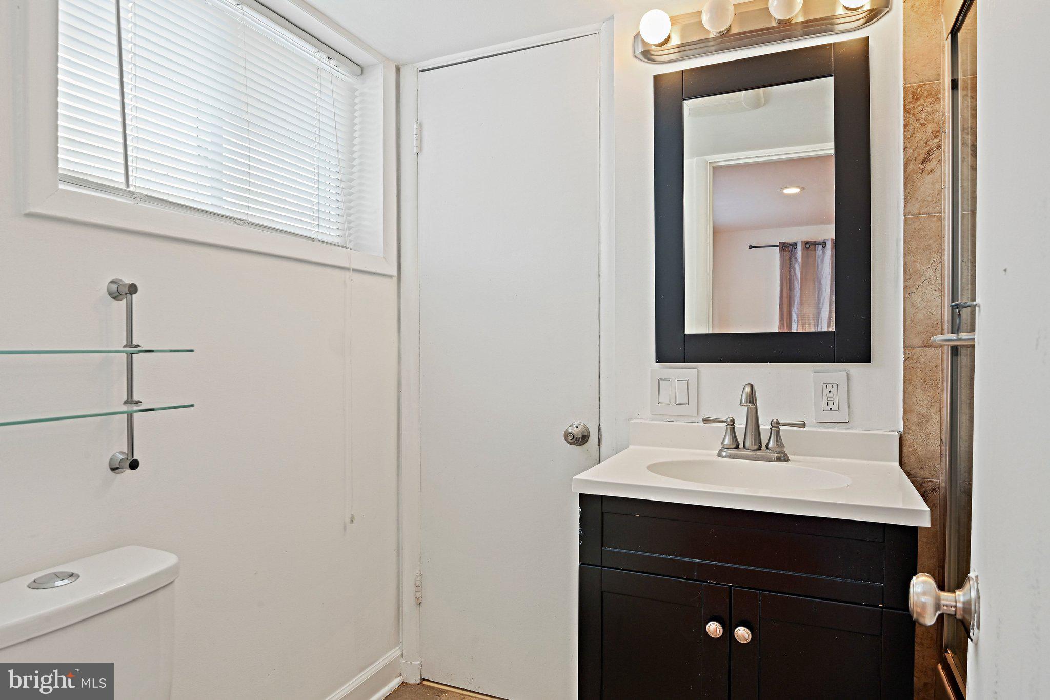 6713 Old Chesterbrook Road McLean, VA 22101 - Photo 8 of 38 a bathroom with a sink a toilet and mirror