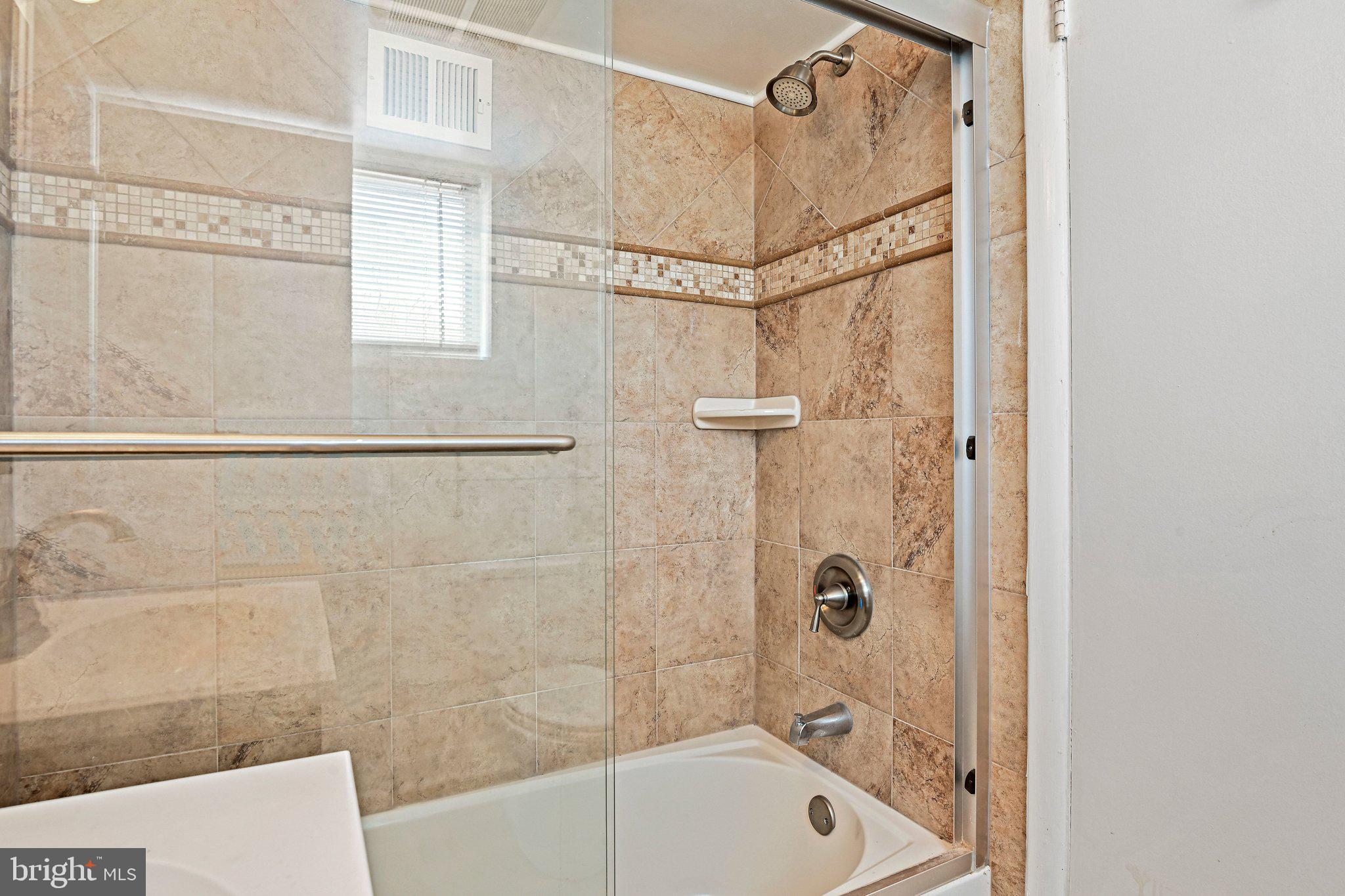 6713 Old Chesterbrook Road McLean, VA 22101 - Photo 9 of 38 a bathroom with a bathtub and shower