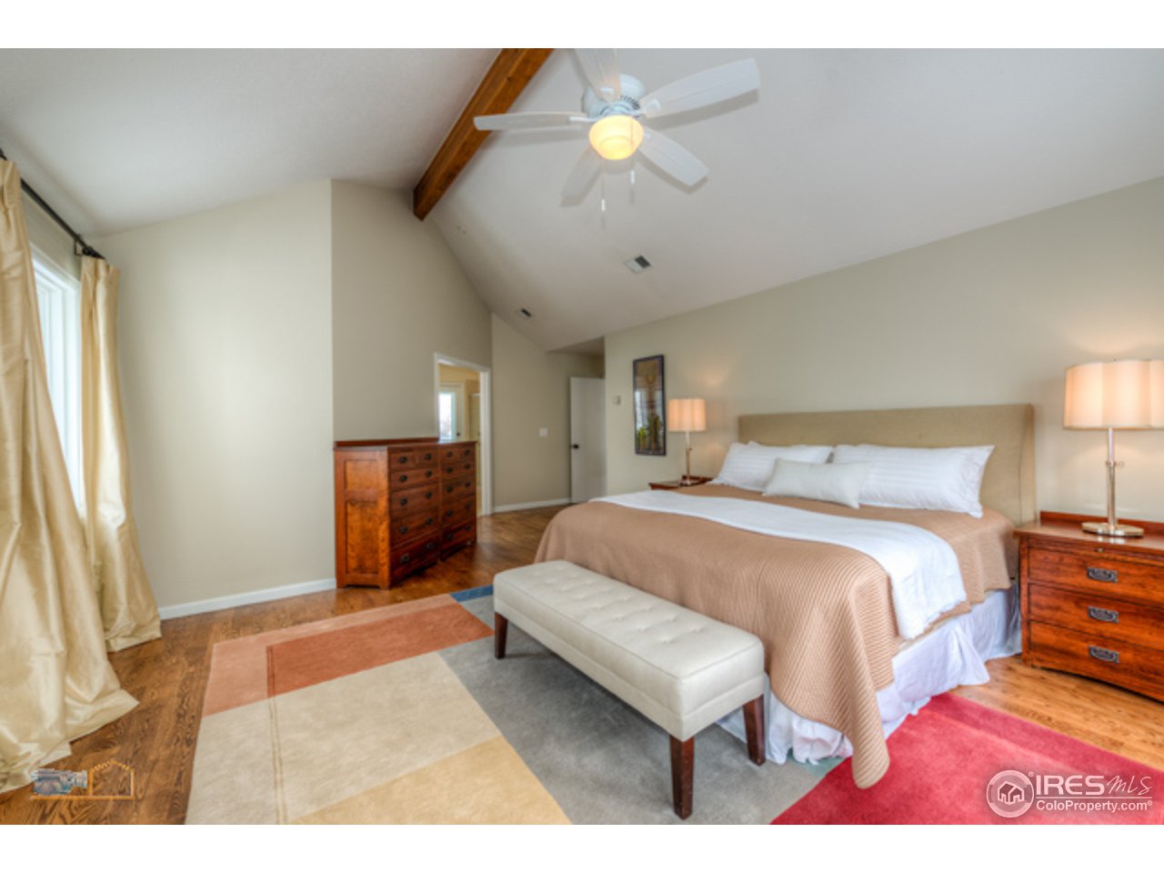 4669 Apple Way Boulder, CO 80301 - Photo 17 of 25 a spacious bedroom with a bed and a chandelier