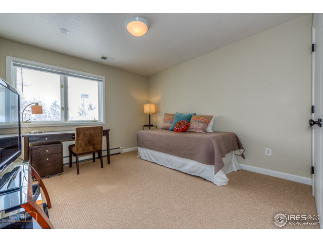 4669 Apple Way Boulder, CO 80301 - Photo 19 of 25 a bedroom with a bed and a dresser next to a window