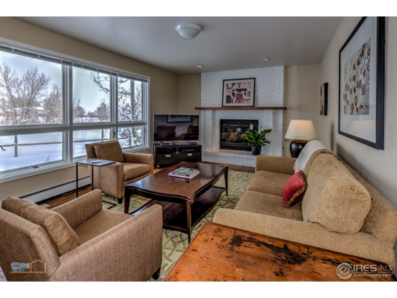 4669 Apple Way Boulder, CO 80301 - Photo 7 of 25 a living room with furniture fireplace and a large window