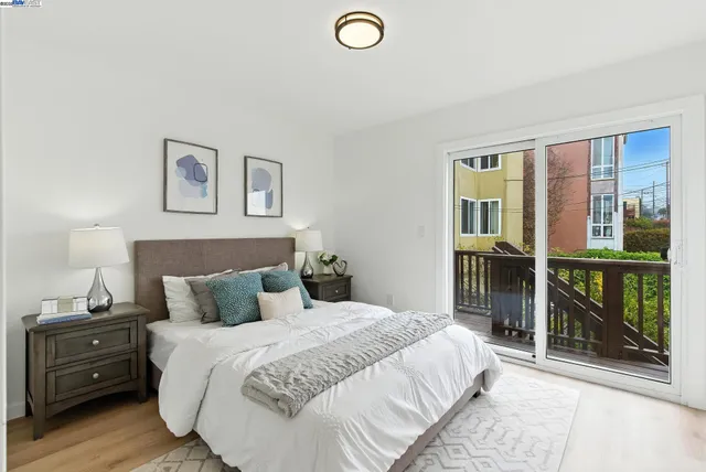 a bedroom with a bed and a lamp next to a window