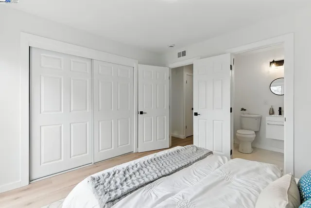 a bedroom with a bed and a toilet