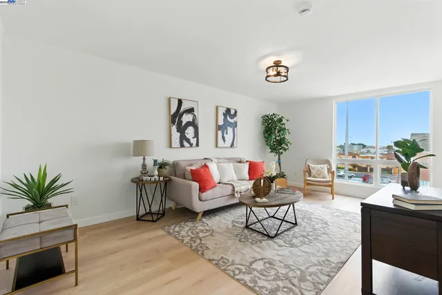 a living room with furniture and a potted plant