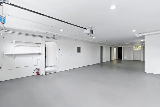 an empty room with closet and a window