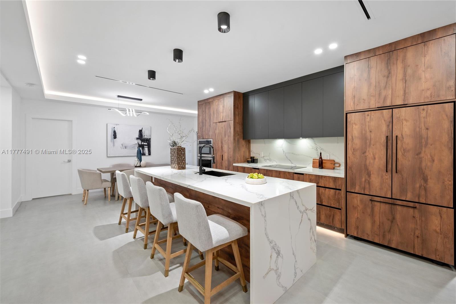 a kitchen with stainless steel appliances a refrigerator a sink dishwasher and a refrigerator