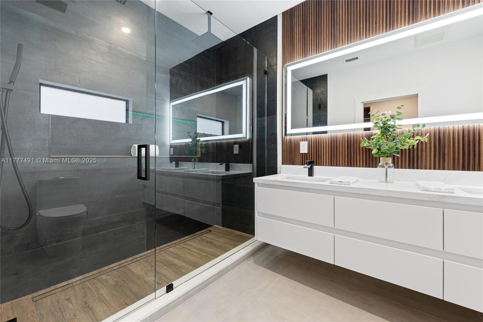 2268 Southwest 16th Terrace Miami, FL 33145 - Photo 17 of 34 a bathroom with a double vanity sink a mirror and a shower