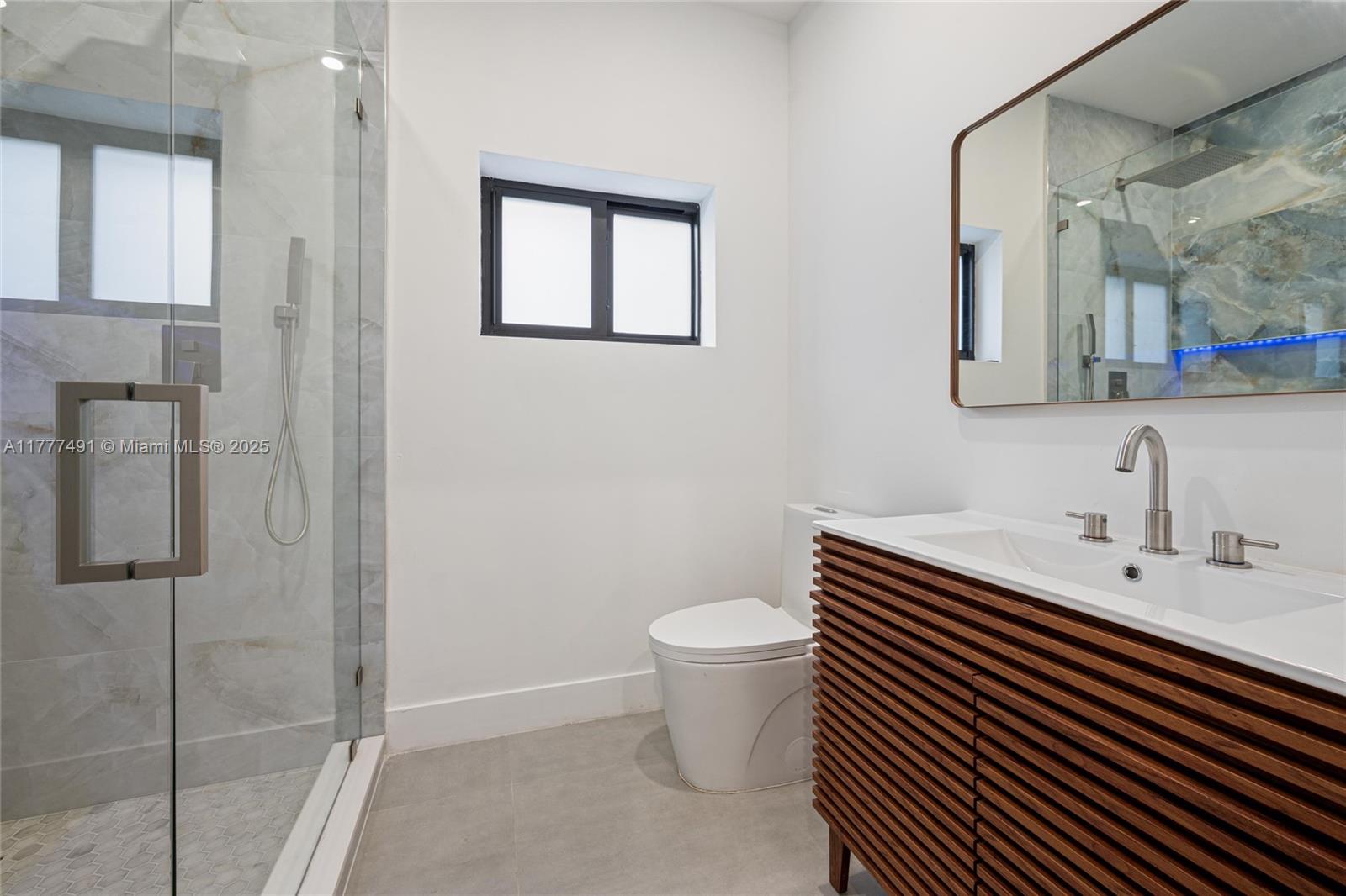 2268 Southwest 16th Terrace Miami, FL 33145 - Photo 23 of 34 a bathroom with a sink toilet and mirror