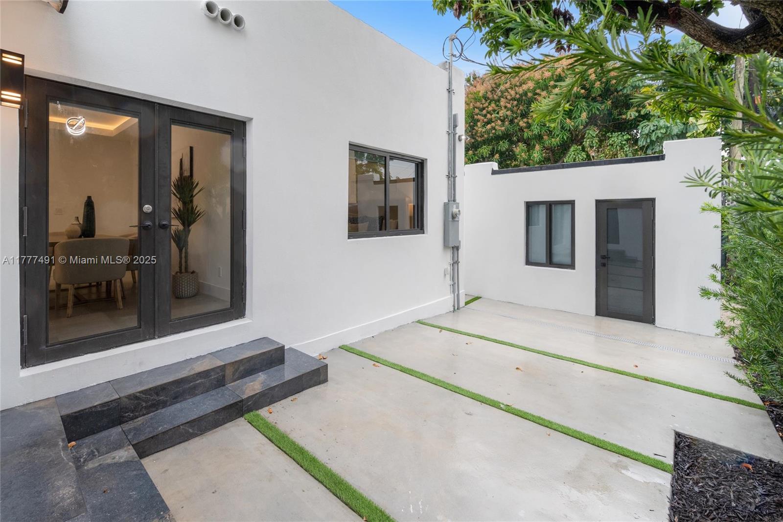 2268 Southwest 16th Terrace Miami, FL 33145 - Photo 25 of 34 a view of a hallway with a couches and dinning table and chairs