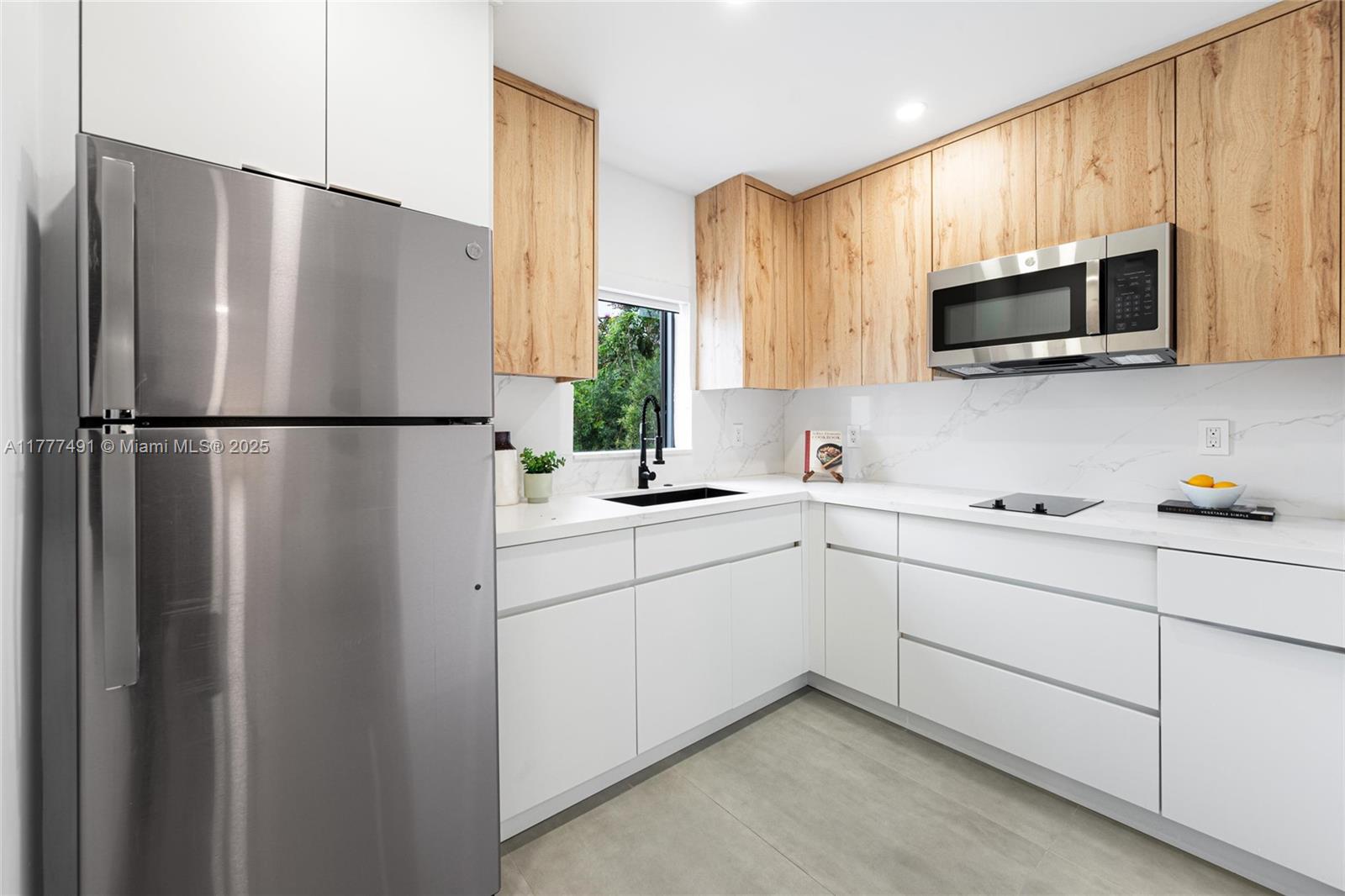 2268 Southwest 16th Terrace Miami, FL 33145 - Photo 30 of 34 a kitchen with stainless steel appliances a refrigerator sink and microwave