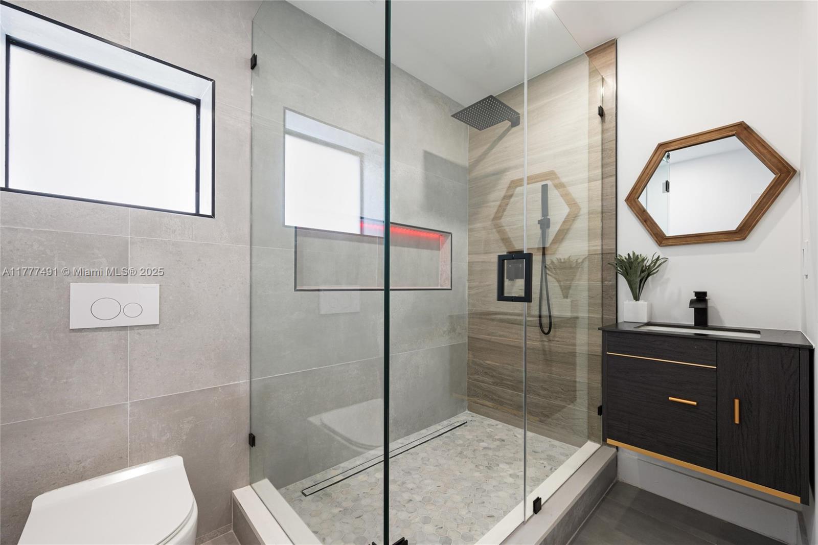 2268 Southwest 16th Terrace Miami, FL 33145 - Photo 31 of 34 a bathroom with a sink mirror and a shower