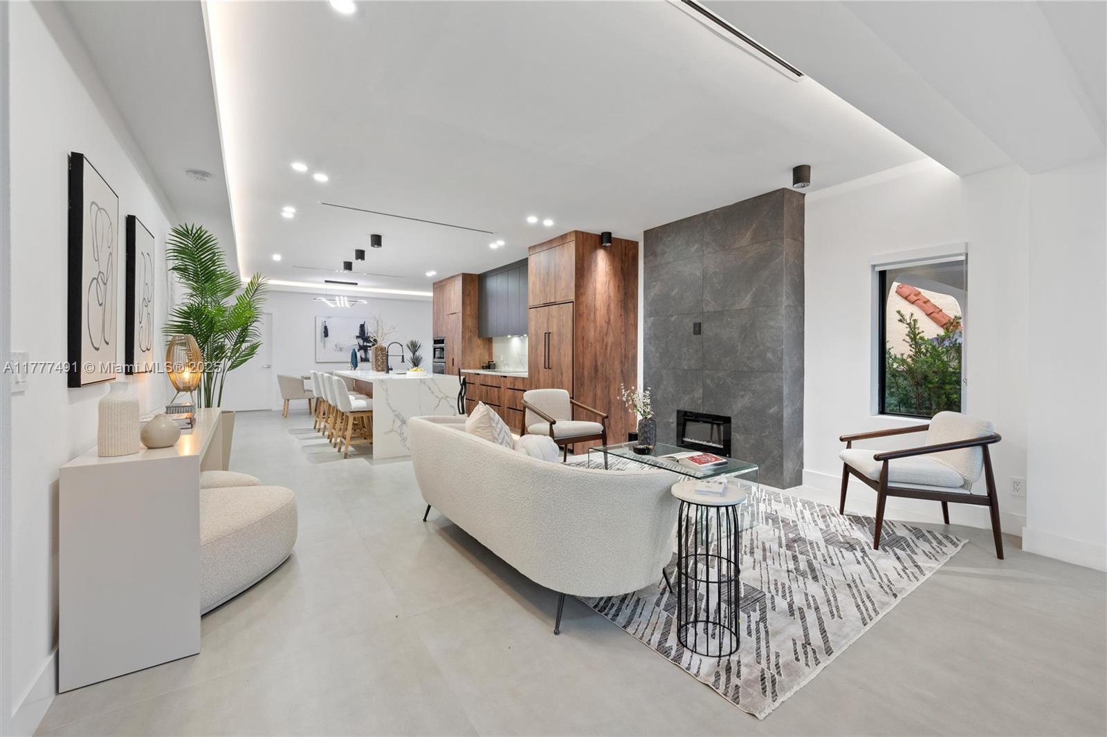 2268 Southwest 16th Terrace Miami, FL 33145 - Photo 5 of 34 a living room with furniture a fireplace and a potted plant