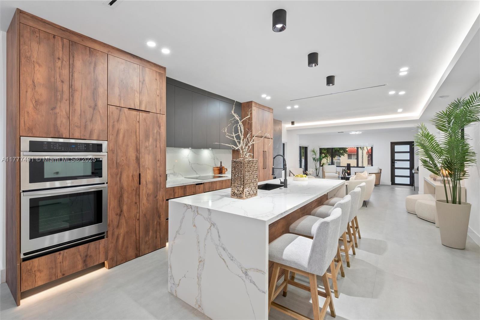 2268 Southwest 16th Terrace Miami, FL 33145 - Photo 9 of 34 a kitchen with a table chairs refrigerator and microwave