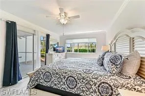 a bedroom with a bed and a large mirror on the dresser