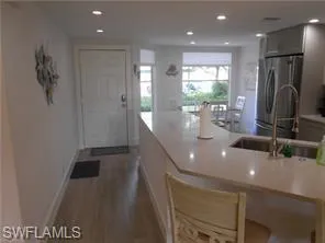 a kitchen with stainless steel appliances granite countertop a refrigerator and a stove top oven