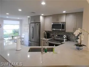 a living room with a flat screen tv and a white wall