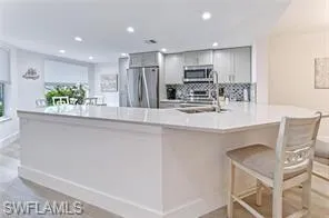 a kitchen with kitchen island cabinets and stainless steel appliances