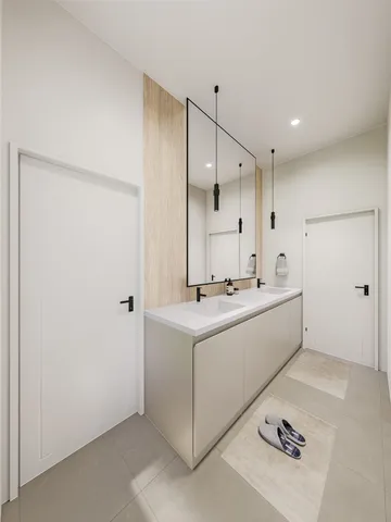a bathroom with a double vanity sink and mirror