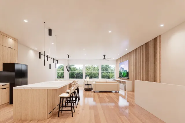 a kitchen with stainless steel appliances kitchen island granite countertop a table chairs and a refrigerator