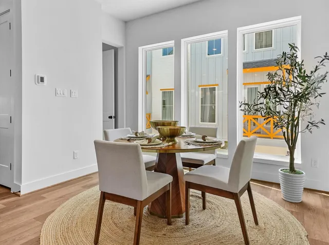 a view of a dining room with furniture window and wooden floor