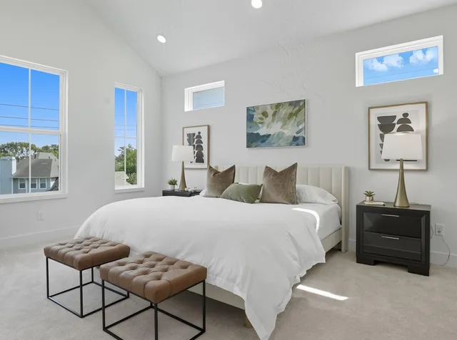 a bedroom with a bed and a painting on the wall