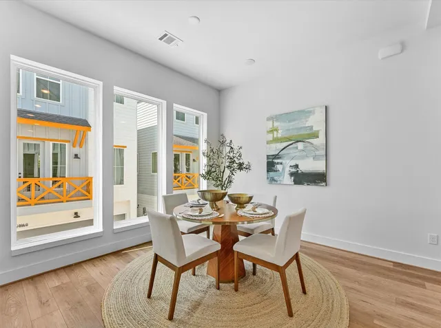 a dining room with furniture and wooden floor