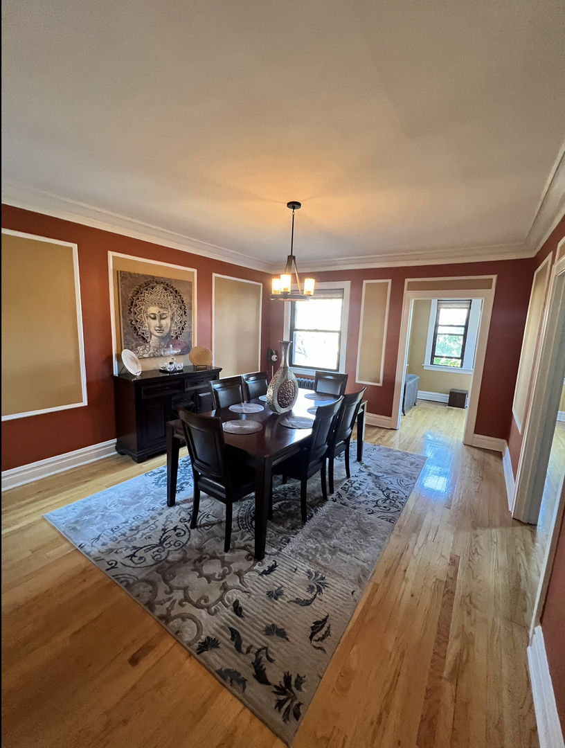 6830 South Paxton Avenue, Unit 3A Chicago, IL 60649 - Photo 5 of 8 a view of a livingroom with furniture window and wooden floor