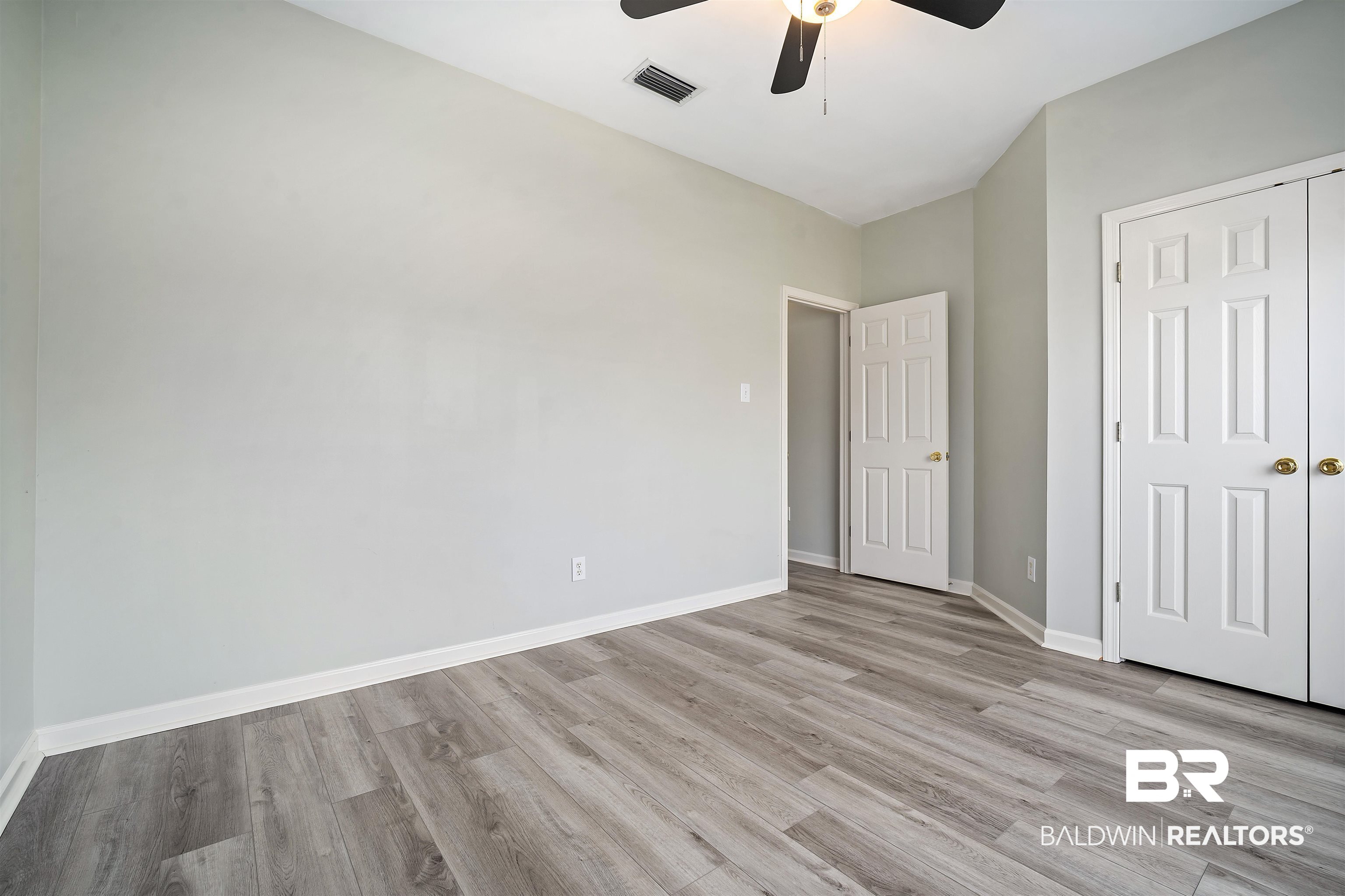 615 Summerlake Place Mobile, AL 36608 - Photo 23 of 35 Unfurnished bedroom featuring light wood-style floors, a ceiling fan, and a closet