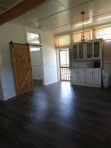 a view of a room with wooden floor and window