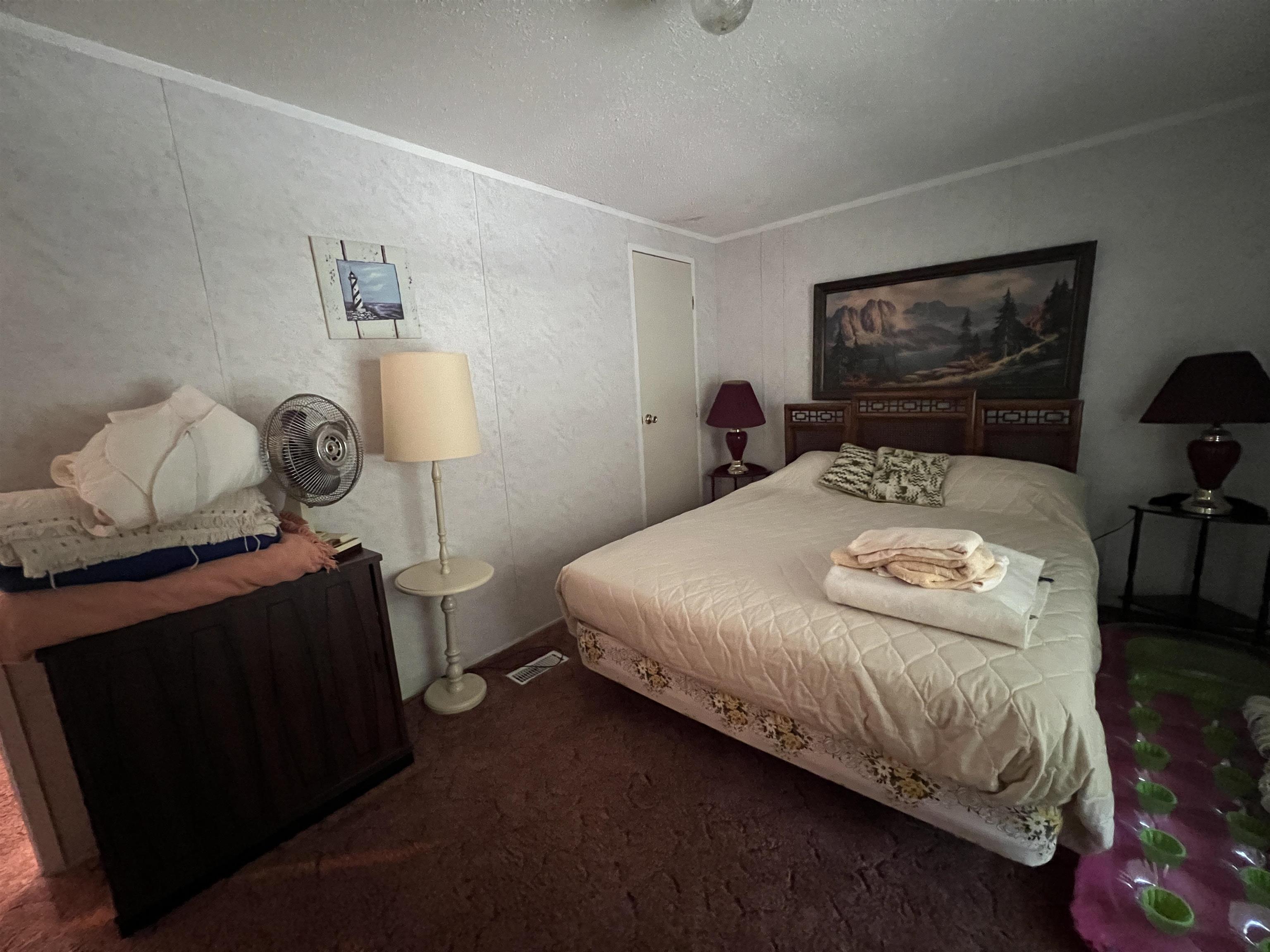 265 Cardinal Road Counce, TN 38326 - Photo 11 of 13 a bedroom with a bed and wooden floor