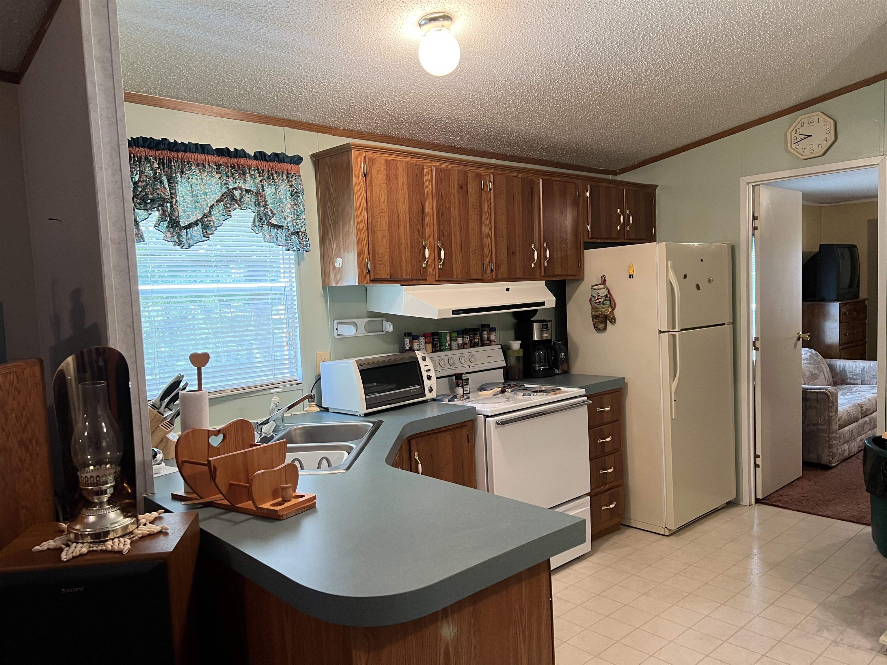 265 Cardinal Road Counce, TN 38326 - Photo 4 of 13 a kitchen with a refrigerator a sink and a stove