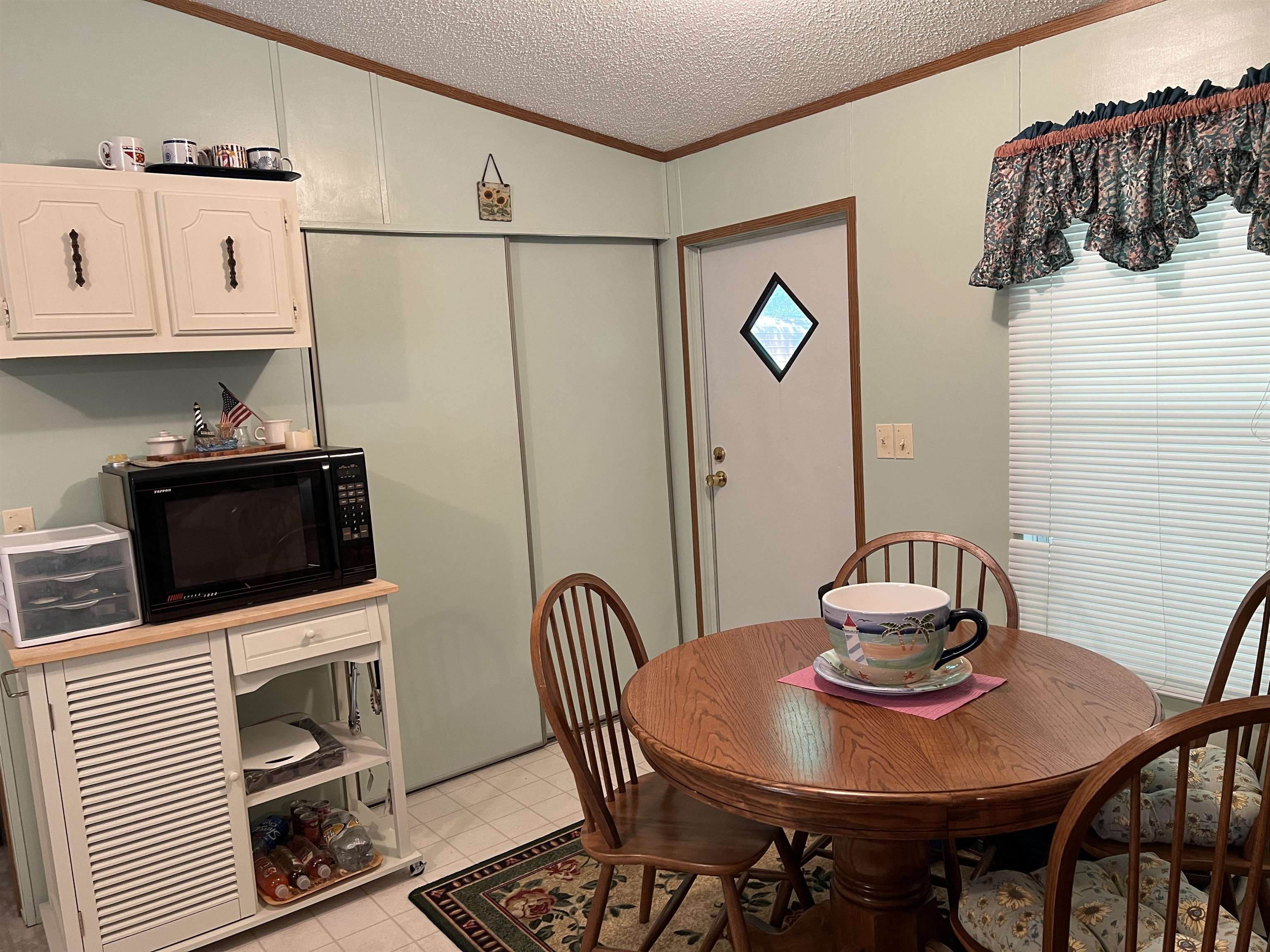 265 Cardinal Road Counce, TN 38326 - Photo 5 of 13 a kitchen with stainless steel appliances a stove a table and chairs