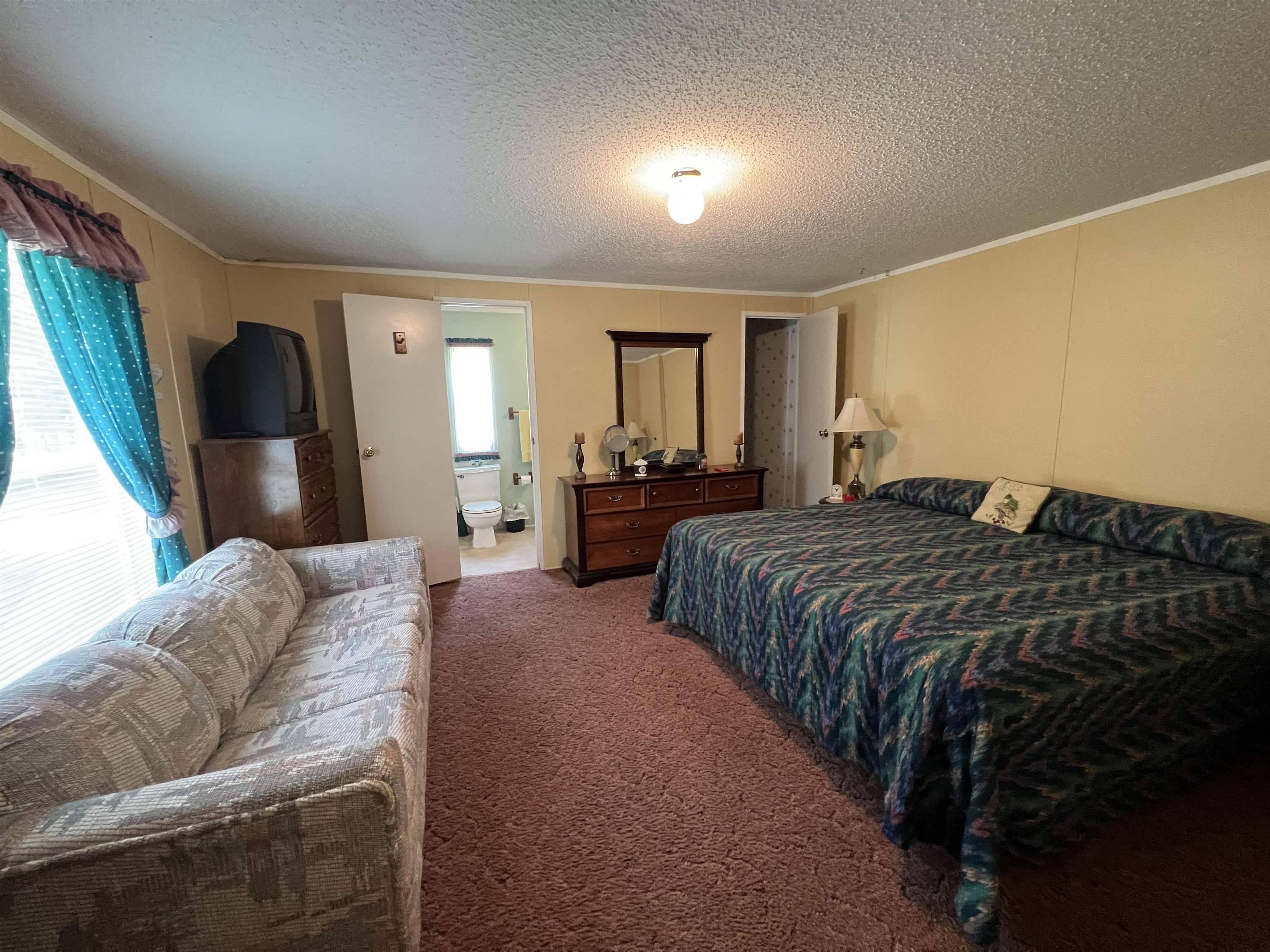 265 Cardinal Road Counce, TN 38326 - Photo 7 of 13 a bedroom with a bed and window