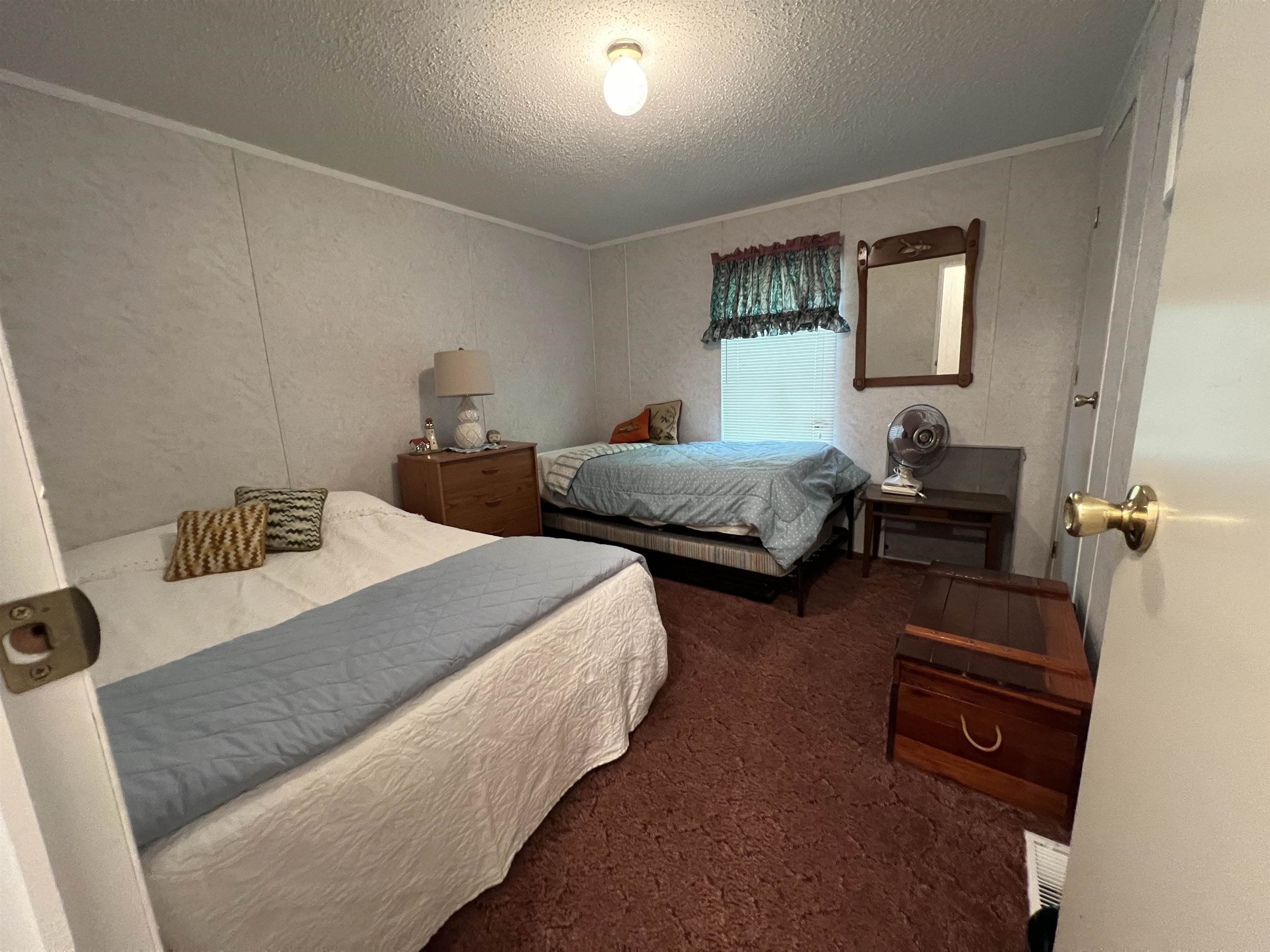 265 Cardinal Road Counce, TN 38326 - Photo 9 of 13 a bedroom with two beds and a couch