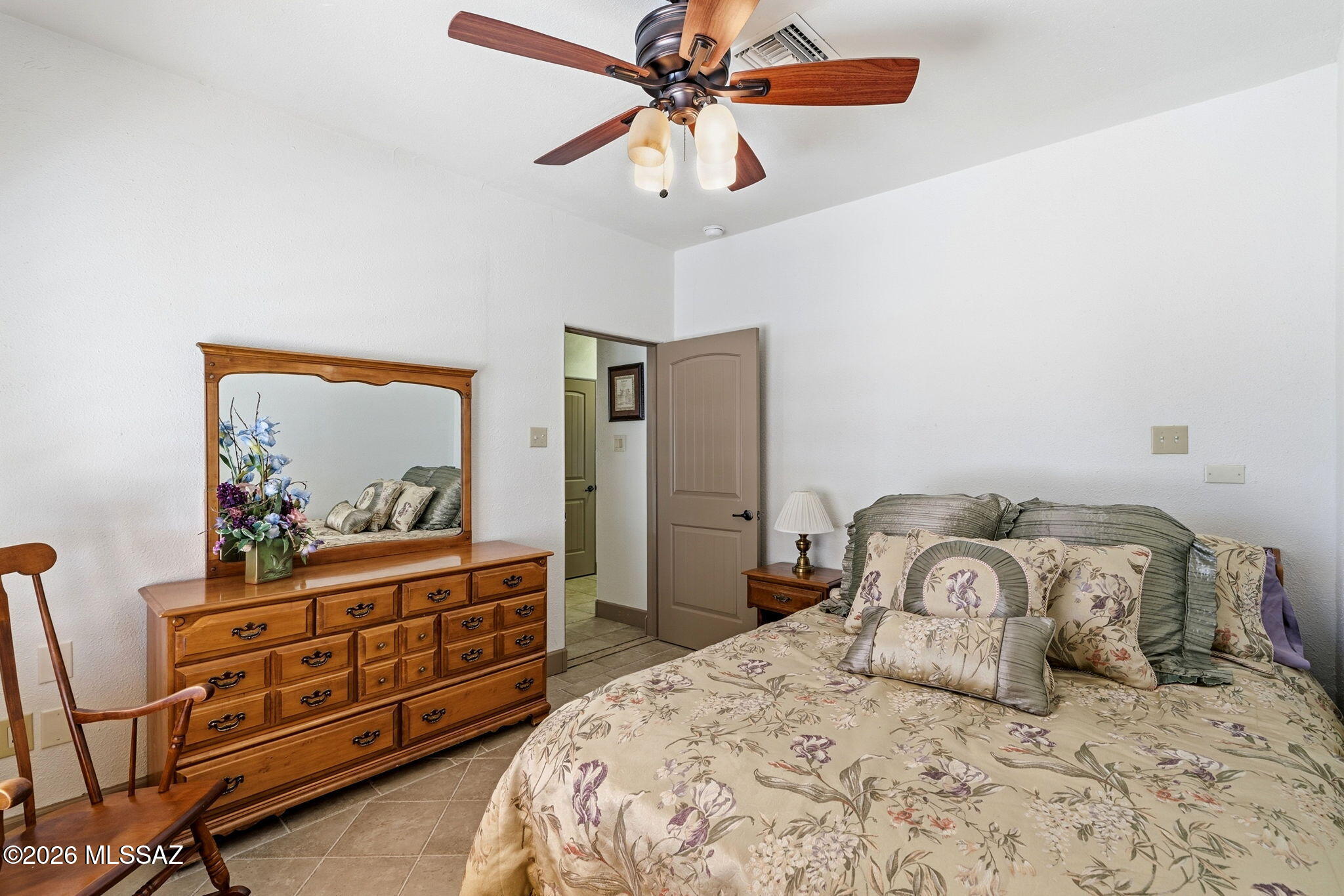 12810 West Gunsmoke Road Tucson, AZ 85736 - Photo 28 of 51 a bedroom with a bed and a chandelier