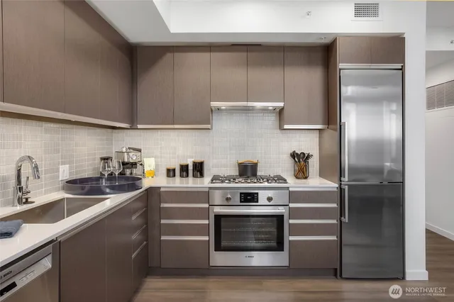 a kitchen with cabinets and stainless steel appliances
