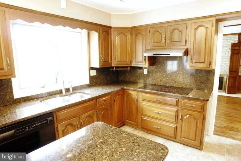 21815 Woodfield Road Gaithersburg, MD 20882 - Photo 9 of 29 Kitchen has granite counter tops.