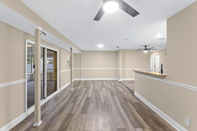 wooden floor in an empty room with a window