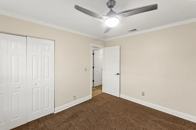 a bathroom with a granite countertop bathtub sink vanity and toilet