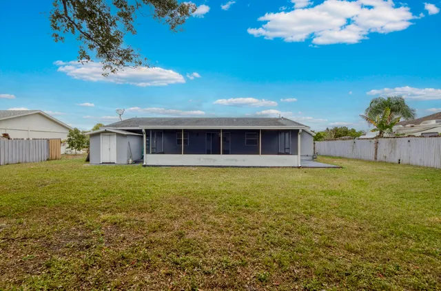 a view of a house with a backyard