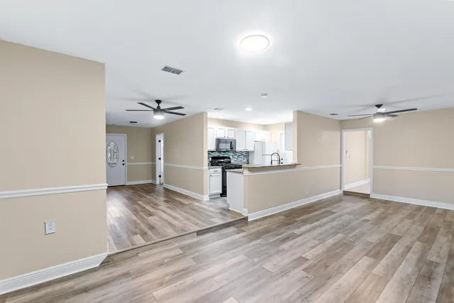 a view of a kitchen with wooden floor