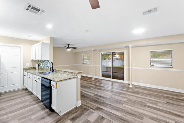 a kitchen with granite countertop a stove and cabinets