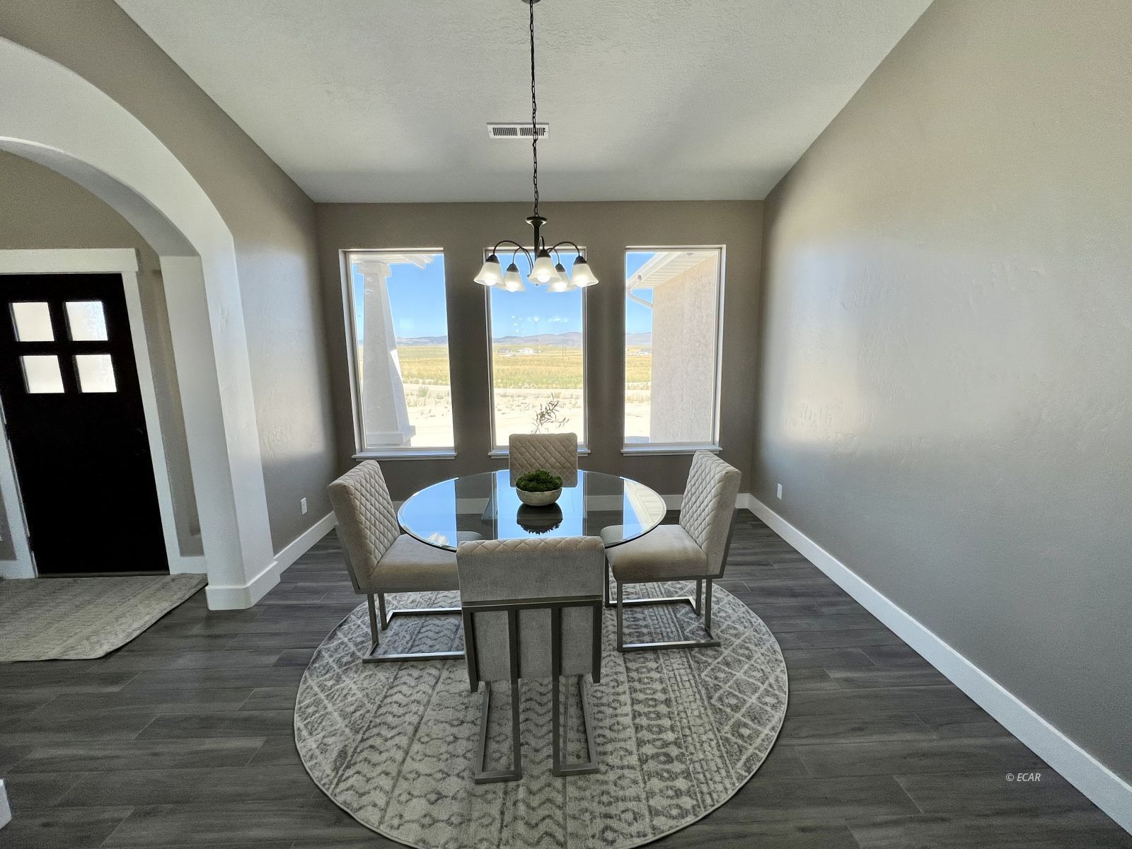 298 Ridgeway Drive Spring Creek, NV 89815 - Photo 8 of 45 a dining room with furniture a chandelier and wooden floor