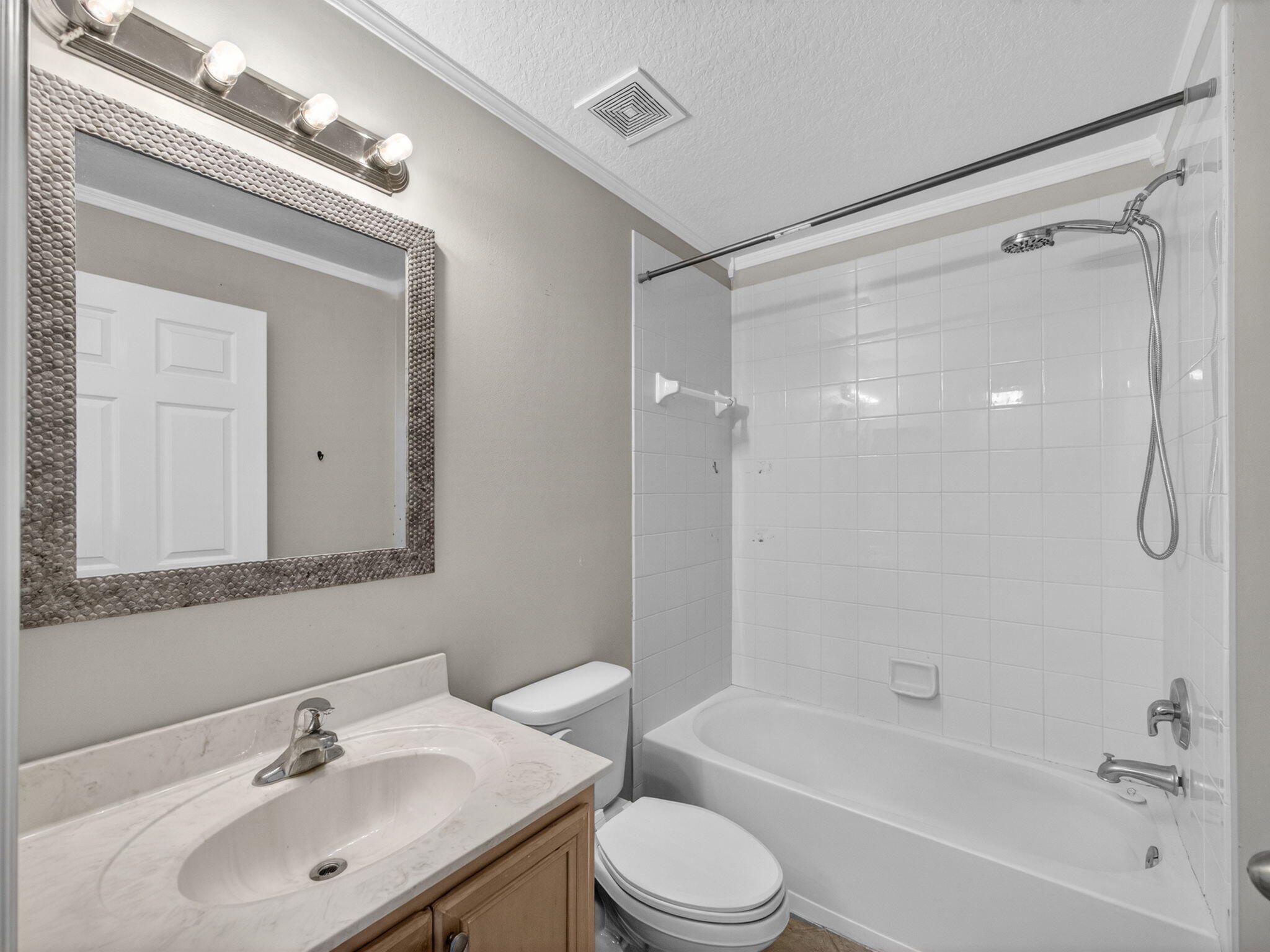 4358 Southeast Graham Drive Stuart, FL 34997 - Photo 25 of 38 a bathroom with a bathtub shower sink vanity and toilet