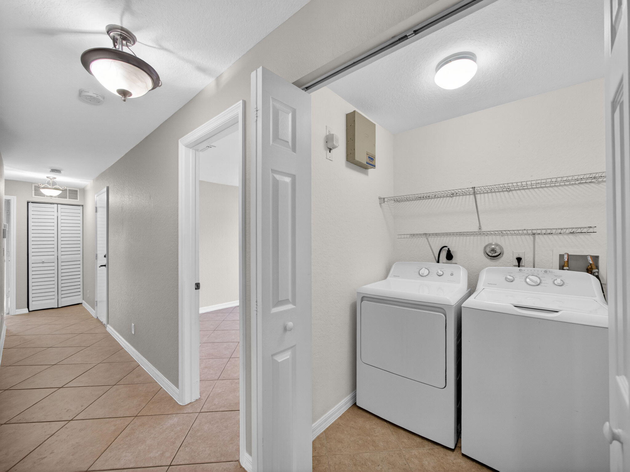 4358 Southeast Graham Drive Stuart, FL 34997 - Photo 26 of 38 a view of a storage & utility room with dryer and washer