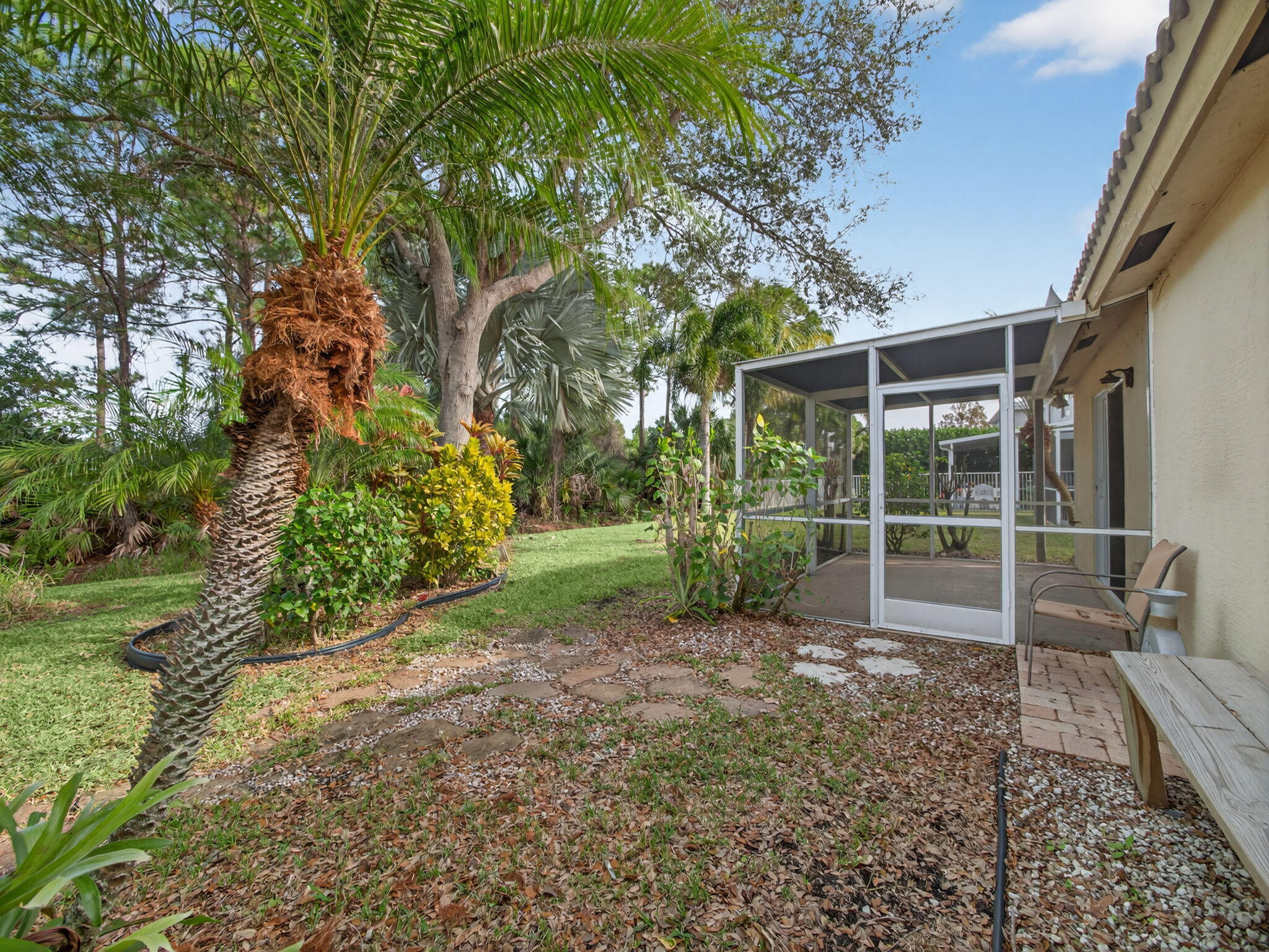 4358 Southeast Graham Drive Stuart, FL 34997 - Photo 29 of 38 a view of a yard with plants and tree