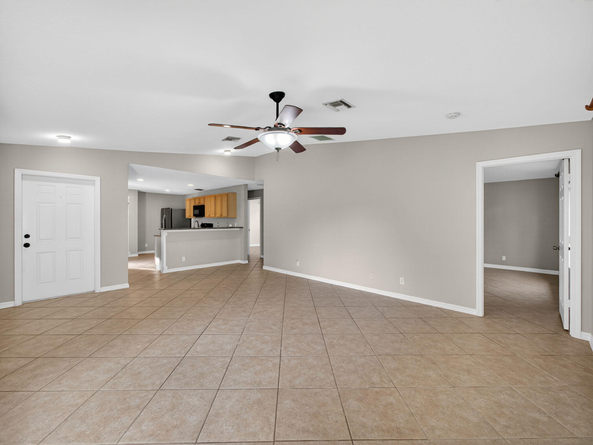 4358 Southeast Graham Drive Stuart, FL 34997 - Photo 8 of 38 a view of an empty room with a ceiling fan